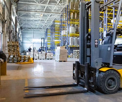 Interior of a modern warehouse with forklifts.